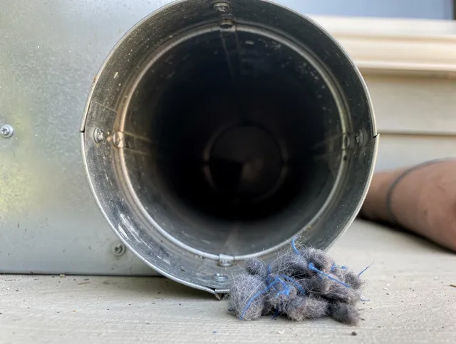 Miami Gardens Dryer Vent Cleaning technician using specialized equipment to clear severe dryer vent blockage in Miami Gardens